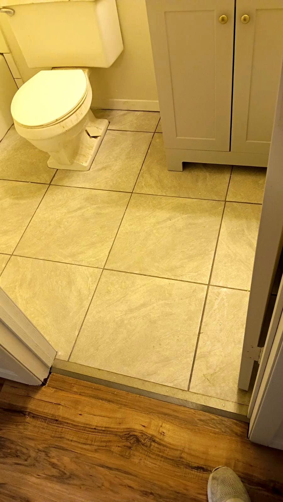 Bathroom interior with pale yellow tile flooring and vanity