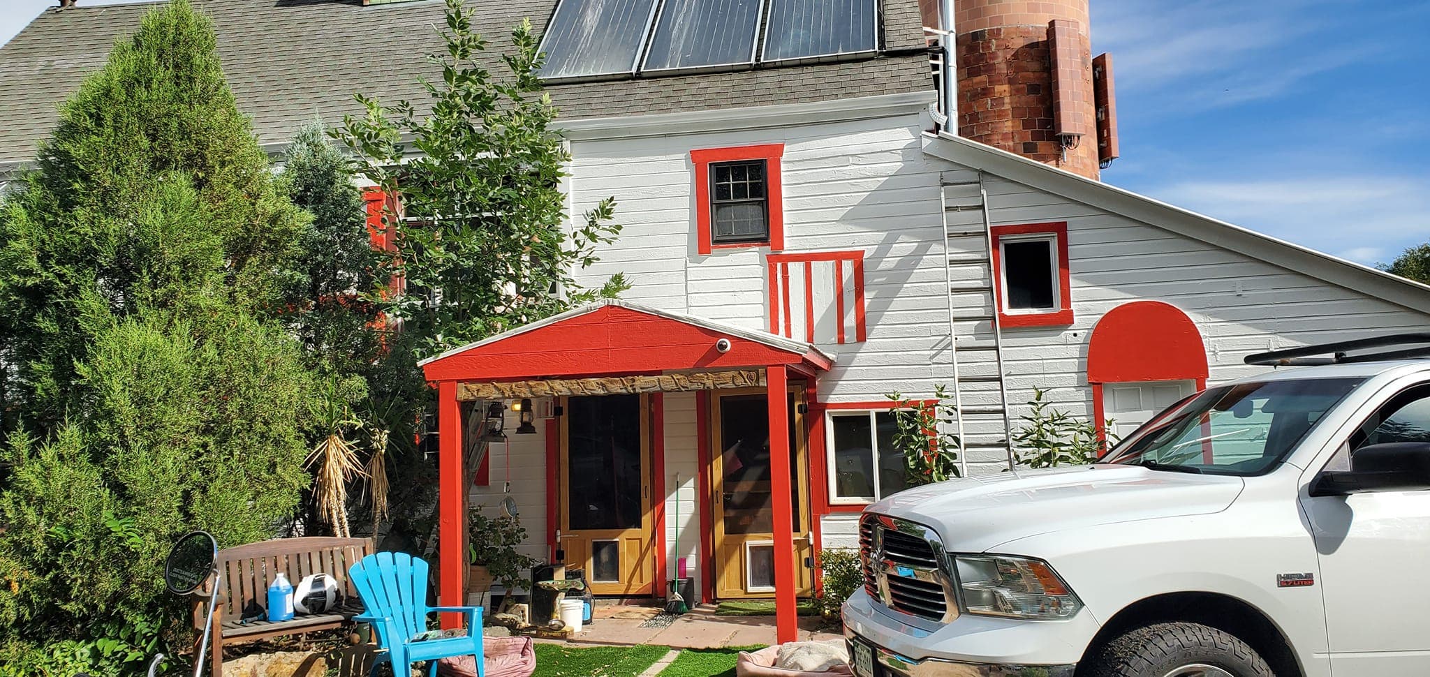 White house with red trim and red awning — exterior painting work