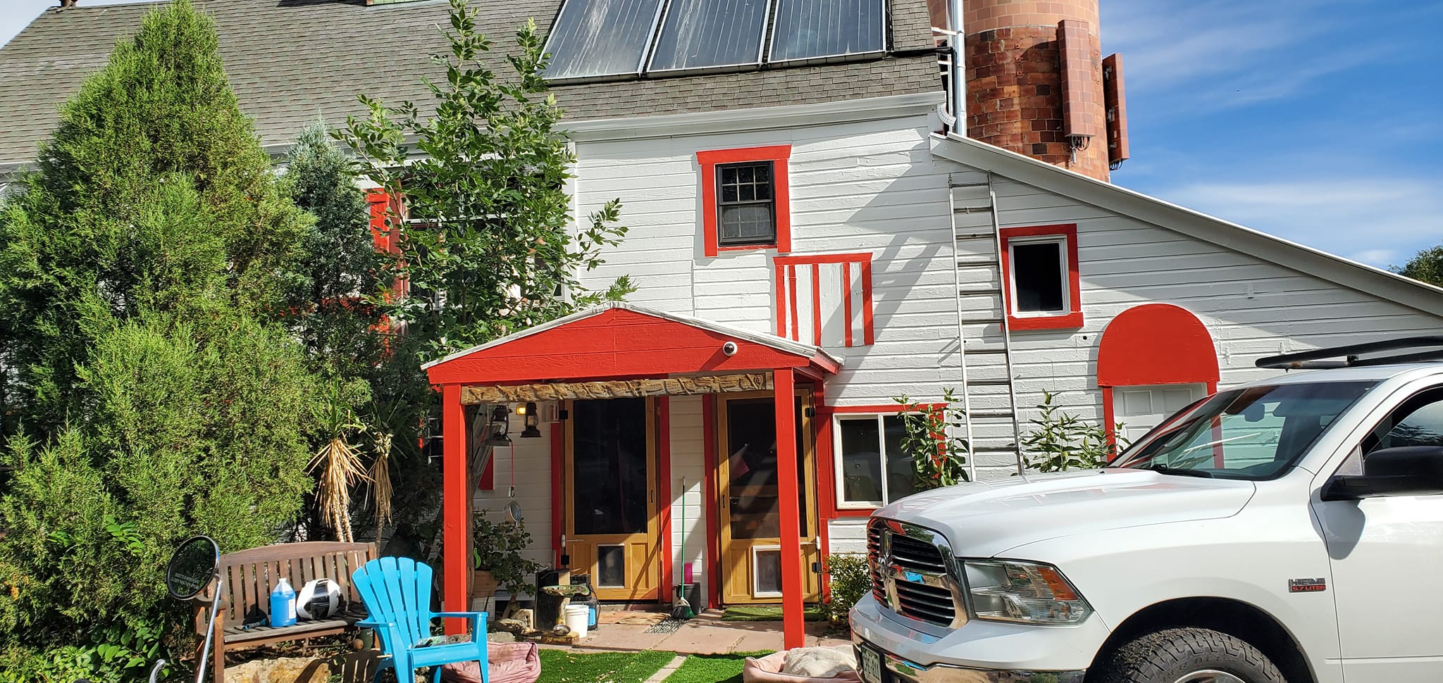 White house with red trim and awning