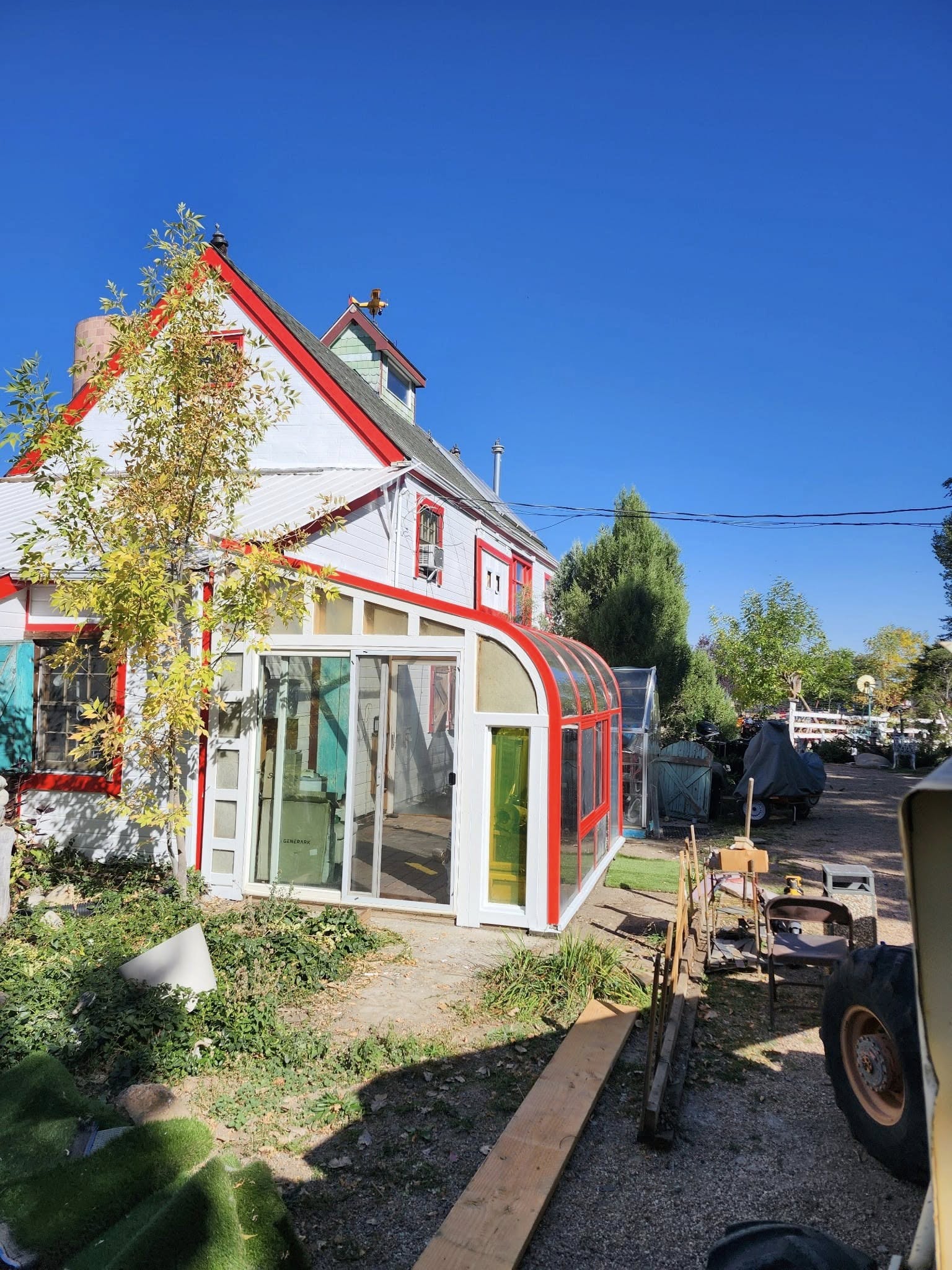 Red-trimmed sunroom on house